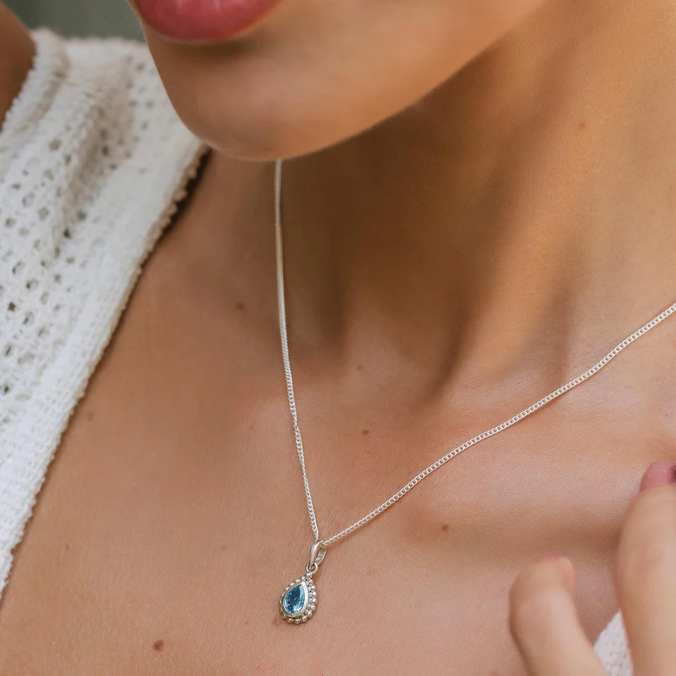 Woman wears birthstone necklace